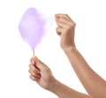 Woman eating yummy cotton candy on white background