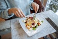 Woman eats a delicious Caesar salad Royalty Free Stock Photo