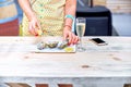 A woman eats fresh oysters on a plate