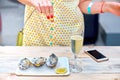 A woman eats fresh oysters on a plate