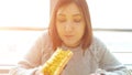 Woman eats a hot dog at a fast food cafe with an appetite Royalty Free Stock Photo