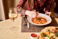 Woman eats Italian pasta with tomato, meat. Close-up spaghetti Bolognese wind it around a fork with a spoon. Parmesan Royalty Free Stock Photo