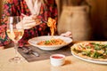 Woman eats Italian pasta with tomato, meat. Close-up spaghetti Bolognese wind it around a fork with a spoon. Parmesan Royalty Free Stock Photo