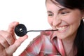 Woman eats a liquorice candy wheel Royalty Free Stock Photo