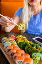 Woman eats traditional sushi rolls. Royalty Free Stock Photo