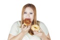 Woman eats two donuts in hand Royalty Free Stock Photo