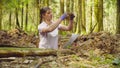Woman ecologist in the forest digging a soil slit