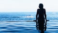 Woman at edge of infinity swimming pool with sea view Royalty Free Stock Photo