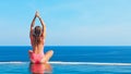 Woman at edge of infinity swimming pool with sea view Royalty Free Stock Photo