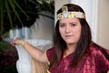 Woman in Egyptian princess costume leaning on vase