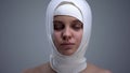 Woman in elastic headwrap with closed eyes, recovery after concussion, medicine