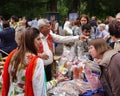 A woman and an elderly man from India sell Indian goods in a summer park