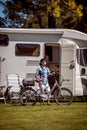 Woman on electric bike resting at the campsite VR Caravan car Va Royalty Free Stock Photo