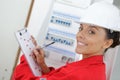 woman electrician checking clipboard results Royalty Free Stock Photo