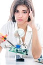 Woman Electronic Technician Repair Electronic Equipment using Electric Soldering Iron