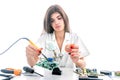 Woman Electronic Technician Repair Electronic Equipment using Electric Soldering Iron