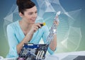 Woman with electronics against blue green background with mesh Royalty Free Stock Photo