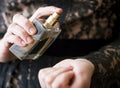 Woman in elegant black lace dress applying perfume on her wrist closeup, selective focus Royalty Free Stock Photo