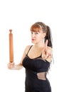 Woman in elegant dress in the kitchen with rolling pin