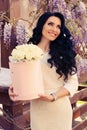 Woman in elegant dress, posing with luxurious bouquet of roses