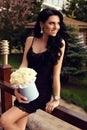 Woman in elegant dress, posing with luxurious bouquet of roses