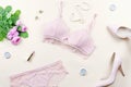 Woman elegant pink lace bra and panties, pumps and jewelry. Stylish lingerie flat lay.