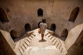 Woman on elevated walkway in Taman Sari underground Mosque