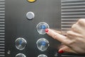 Woman in elevator or lift is pressing button to get into right floor only hand to be seen - close-up. 13 th floor Royalty Free Stock Photo