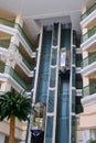 Woman in the elevator lobby of the arab hotel. Palm tree and balconi in a hotel building in Tunisia Royalty Free Stock Photo