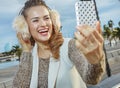 Woman on embankment in Barcelona taking selfie with smartphone Royalty Free Stock Photo