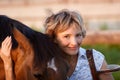 Woman embrace brown horse