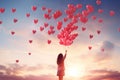 A woman embracing a colorful bunch of heart-shaped balloons with a joyful smile, Person releasing a bunch of heart balloons into Royalty Free Stock Photo