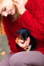 Woman embrancing her puppy dog