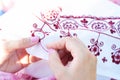 Woman Embroiders floral ornament on linen Royalty Free Stock Photo