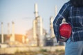 Woman Emergency workers hands holding hardhat red work helmet Engineer. Refinery plant woman worker oil petrochemical industry Royalty Free Stock Photo