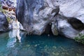 Woman emerges from water cave