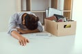 Woman employee feeling sad at his desk when he received the contract envelope for resigning from the company