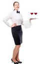 Woman employee of the restaurant with wine glasses on a tray