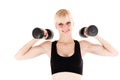 Woman is engaged with dumbbells