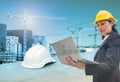 Woman engineer holding laptop with helmet on construction building with cranes Royalty Free Stock Photo