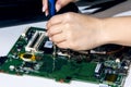 Woman engineer replace cpu from laptop motherboard Royalty Free Stock Photo