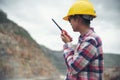 Woman Engineer and safety Officer concept.Young woman engineer talking portable radio, and wear safety hat helmet and safety