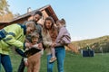 Woman engineer talking to young family about solar panel installation in front of their house.