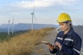 Woman engineer is wearing a protective helmet on her head, using tablet Analytics engineering data Royalty Free Stock Photo