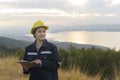 Woman engineer is wearing a protective helmet on her head, using tablet Analytics engineering data Royalty Free Stock Photo