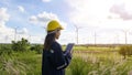 Woman engineer is wearing a protective helmet on her head, using tablet Analytics engineering data Royalty Free Stock Photo