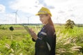 Woman engineer is wearing a protective helmet on her head, using tablet Analytics engineering data Royalty Free Stock Photo