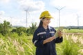 Woman engineer is wearing a protective helmet on her head, using tablet Analytics engineering data Royalty Free Stock Photo