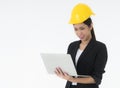 Woman engineers wearing a black suit and Yellow Safety helmet Standing to work with a computer notebook isolated on white backgrou