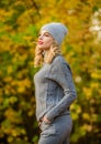 Woman enjoy autumn season in park. Warm knitwear. Feel practicality and comfort. Model knitwear clothes leaves